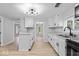 Open concept kitchen features white cabinets, stainless appliances, updated countertops, and luxury vinyl plank flooring at 5136 Miller St, Indianapolis, IN 46241