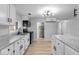 Renovated kitchen features modern white cabinets, stainless appliances, and updated countertops at 5136 Miller St, Indianapolis, IN 46241