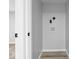 A well-lit laundry room boasts convenient hookups and modern, light-toned walls and flooring at 5136 Miller St, Indianapolis, IN 46241