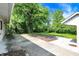 View of a backyard featuring a concrete patio, wood deck, and mulched garden at 5236 Daniel Dr, Indianapolis, IN 46226