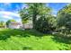 Spacious backyard featuring a shed, mature trees and plenty of green space, ideal for outdoor activities at 5236 Daniel Dr, Indianapolis, IN 46226
