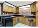 Finished bar with ample cabinet space, sink, mini fridge, and black counter at 5236 Daniel Dr, Indianapolis, IN 46226