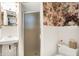 Traditional bathroom with floral wallpaper, shower, sink, toilet, and mirrored medicine cabinet at 5236 Daniel Dr, Indianapolis, IN 46226