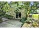 Exterior view of home with stone facade, sliding glass door, patio and landscaped stone steps at 5236 Daniel Dr, Indianapolis, IN 46226