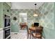 Eat-in kitchen with updated appliances, tiled flooring, and decorative wallpaper at 5236 Daniel Dr, Indianapolis, IN 46226