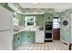 Quaint kitchen with updated appliances, white counters, and green cabinets at 5236 Daniel Dr, Indianapolis, IN 46226