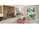 Cozy living room with stone fireplace, floral accents, and sliding glass door at 5236 Daniel Dr, Indianapolis, IN 46226