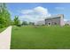 Expansive backyard with lush green grass, a sidewalk, and fencing, offering ample space for outdoor activities at 5335 Rum Cherry Way, Indianapolis, IN 46237