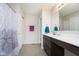 Bathroom featuring dark wood cabinets, a large mirror, and a shower with a curtain at 5335 Rum Cherry Way, Indianapolis, IN 46237