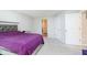 Bright bedroom featuring neutral carpet, modern furniture, two closets, and a door to the bathroom at 5335 Rum Cherry Way, Indianapolis, IN 46237