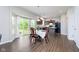 Cozy dining area, showcasing hardwood flooring, and ample natural light, adjacent to the kitchen at 5335 Rum Cherry Way, Indianapolis, IN 46237