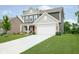 Charming two-story home with landscaped lawn and a spacious driveway leading to a two car garage at 5335 Rum Cherry Way, Indianapolis, IN 46237