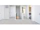 Bright and airy hallway featuring neutral carpets and white doors at 5335 Rum Cherry Way, Indianapolis, IN 46237