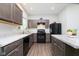 A well-lit kitchen features dark cabinetry, laminate countertops, and black appliances at 5335 Rum Cherry Way, Indianapolis, IN 46237