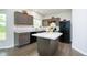 Well-lit kitchen with granite countertops, an island, and modern appliances next to the dining area at 5335 Rum Cherry Way, Indianapolis, IN 46237