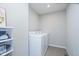 Bright laundry room with washer, dryer, and shelving for storage at 5335 Rum Cherry Way, Indianapolis, IN 46237