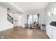 Bright living room with stylish flooring, a staircase and a window overlooking a landscaped yard at 5335 Rum Cherry Way, Indianapolis, IN 46237