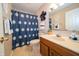 Cozy bathroom featuring a vanity with a sink, toilet, decorative mirror, and shower at 5352 Steinmeier N Dr, Indianapolis, IN 46220