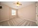 Neutral bedroom with carpet, ceiling fan, and a bright window at 5352 Steinmeier N Dr, Indianapolis, IN 46220