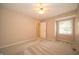 Neutral bedroom featuring carpeted floors, a window, and a ceiling fan at 5352 Steinmeier N Dr, Indianapolis, IN 46220