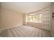 Bright bedroom with built-in bookshelves and a large window showcasing backyard views at 5352 Steinmeier N Dr, Indianapolis, IN 46220