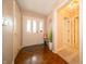 Inviting foyer featuring hardwood floors, neutral walls, and decorative lighting fixtures at 5352 Steinmeier N Dr, Indianapolis, IN 46220