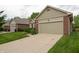 View of a single-story home with brick facade, green lawn, and an attached one car garage at 5352 Steinmeier N Dr, Indianapolis, IN 46220