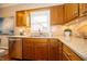 Kitchen featuring stainless steel appliances, wooden cabinets, and granite countertops at 5352 Steinmeier N Dr, Indianapolis, IN 46220