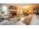 Open-concept living room with brick fireplace and dining area, perfect for entertaining at 5352 Steinmeier N Dr, Indianapolis, IN 46220