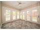Inviting sunroom with multiple windows, tile flooring, and serene backyard views at 5352 Steinmeier N Dr, Indianapolis, IN 46220