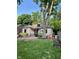 Spacious backyard featuring a patio area, mature trees, and ample lawn space at 5677 Carrollton Ave, Indianapolis, IN 46220