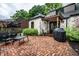 Charming backyard patio with brickwork, outdoor seating, grill, and mature landscaping at 5677 Carrollton Ave, Indianapolis, IN 46220