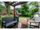 Inviting backyard with comfortable seating, a pergola, brick patio, and lush landscaping at 5677 Carrollton Ave, Indianapolis, IN 46220