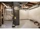 Unfinished basement with concrete flooring and wall protection at 5677 Carrollton Ave, Indianapolis, IN 46220