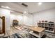 Open basement area includes a stylish bar setup, comfortable seating, and ample storage space, ideal for entertaining guests at 5677 Carrollton Ave, Indianapolis, IN 46220
