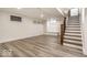 Finished basement offers neutral paint, recessed lights, and stairs with decorative wrought iron at 5677 Carrollton Ave, Indianapolis, IN 46220