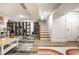 Finished basement offers a bright, versatile space with stylish flooring and an inviting staircase for easy access to other floors at 5677 Carrollton Ave, Indianapolis, IN 46220