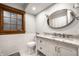 Updated bathroom featuring granite countertop, subway tile, and natural wood window trim at 5677 Carrollton Ave, Indianapolis, IN 46220