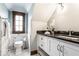 Well-lit bathroom with black granite countertops, marble accents, and modern fixtures at 5677 Carrollton Ave, Indianapolis, IN 46220