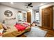 Cozy bedroom with natural wood trim, a ceiling fan, and a comfortable rug at 5677 Carrollton Ave, Indianapolis, IN 46220