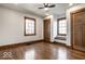 Spacious bedroom with wood floors, natural light, and doors leading to other rooms at 5677 Carrollton Ave, Indianapolis, IN 46220