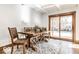 Bright dining room features a wooden table, chairs, and an area rug beneath a decorative ceiling at 5677 Carrollton Ave, Indianapolis, IN 46220