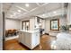 Bright kitchen featuring a center island, stainless appliances, and charming natural wood window trim at 5677 Carrollton Ave, Indianapolis, IN 46220
