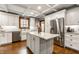 Charming kitchen with gray island, stainless steel appliances, and subway tile backsplash at 5677 Carrollton Ave, Indianapolis, IN 46220