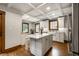 Bright kitchen featuring an island, coffered ceilings, and natural wood window trim at 5677 Carrollton Ave, Indianapolis, IN 46220