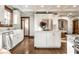 Bright kitchen featuring white cabinets, stainless steel appliances, and a center island at 5677 Carrollton Ave, Indianapolis, IN 46220