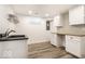 Laundry room with granite counters, plank flooring, white cabinets and open shelving at 5677 Carrollton Ave, Indianapolis, IN 46220