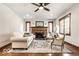 Bright living room featuring a fireplace, hardwood floors, and large windows at 5677 Carrollton Ave, Indianapolis, IN 46220