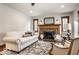 Bright living room featuring a fireplace, hardwood floors, and large windows at 5677 Carrollton Ave, Indianapolis, IN 46220