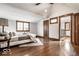 Bright primary bedroom with hardwood floors, a cozy bed, and tasteful decor at 5677 Carrollton Ave, Indianapolis, IN 46220